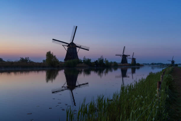 istock Traditional Dutch windmills with a colourful sky just before sunrise in Kinderdijk, The Netherlands 1995508128