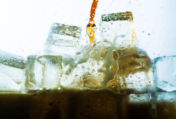 istock Close up cola pouring with ice and bubble in glass on white background cold drink beverage 1995511241