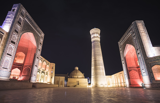Evening exterior of Kalon Po-i-Kalyan Mosque, Mir Arab madrasasi and Kalyan Minaret in the ancient city of Bukhara in Uzbekistan, night view of madrasah, mosque and minaret
