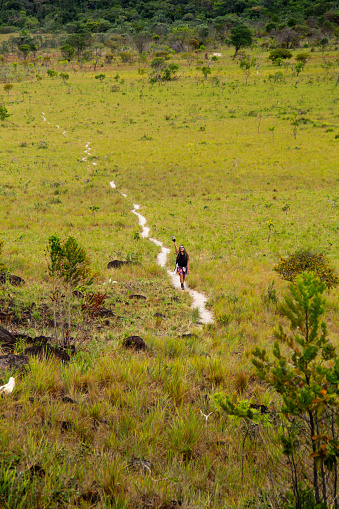 happy hiking female in mountain trail or path enjoying nature in Canaima National Park, Venezuela