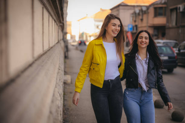 istock Two beautiful young women walking and laughing together 1995546864