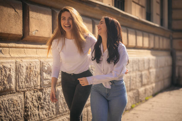 Two young girls walking around the city.