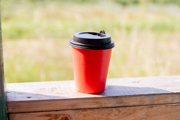 Take-away paper coffee red cup on table