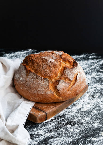 istock Sourdough bread with crispy crust on wooden board 1995561597