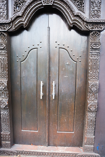 a javanese traditional wooden door. surabaya, indonesia - 4 january 2024