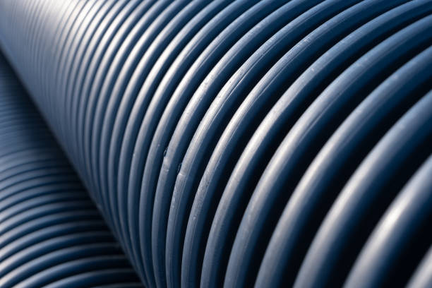 istock Close-up view on black plastic corrugated drain pipe ribs texture 1995596042
