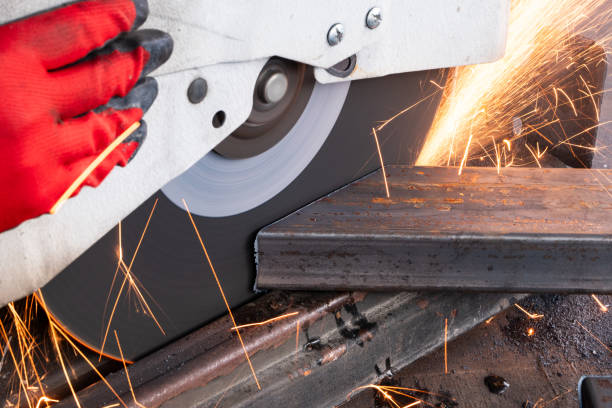istock Worker Cutting of a Rectangular Steel Tube With a Circular Saw, creating sparks 1995600516