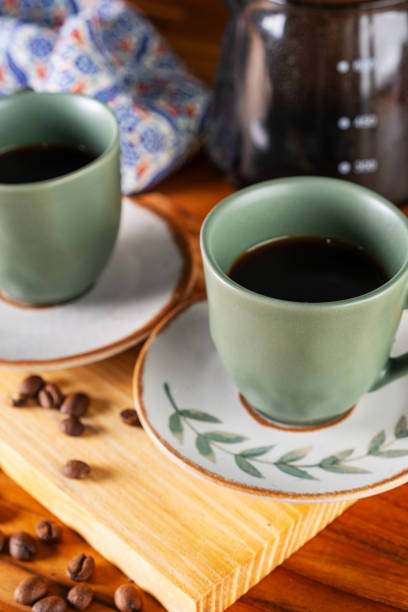 istock two cups of coffee and strainer used in the background 1995630272