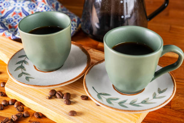 istock two cups of coffee and strainer used in the background 1995630788