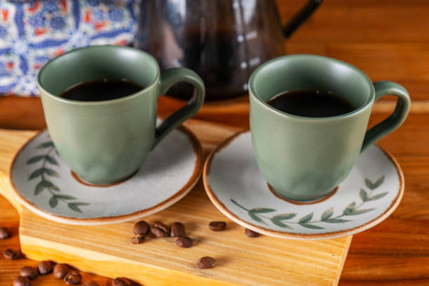istock two cups of coffee and strainer used in the background 1995664465