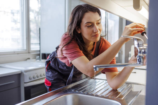 istock A Handywoman installing a faucet in the kitchen 1995670157