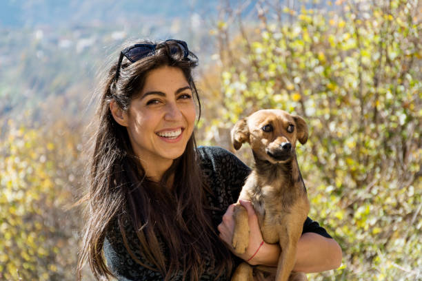 istock Woman hugging her adopted dog in the mountain 1995671714