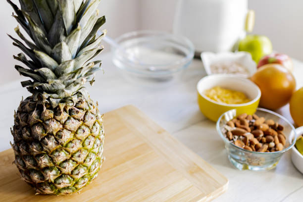 Healthy ingredients for tasty breakfast. Pineapple, cereal, grapefruit, apple, almonds.
