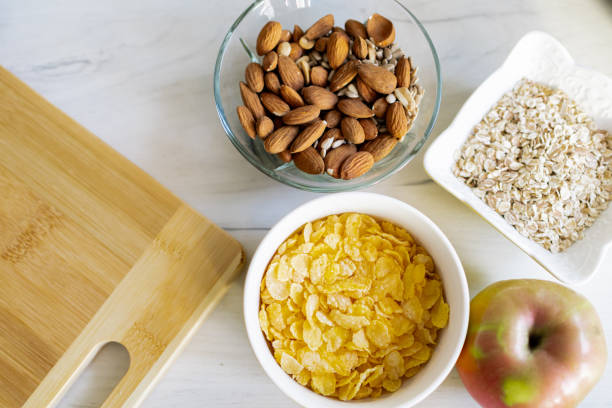 Healthy ingredients for tasty breakfast. Cereal, corn flakes, almond, apple.
