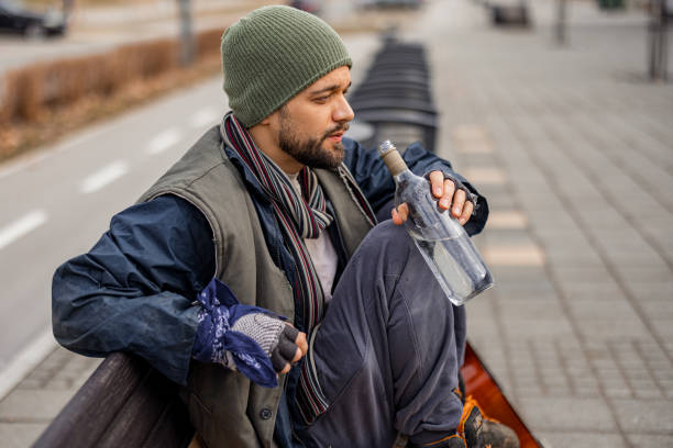 istock Homeless Alcoholic Man Sitting on the Bench 1995715014