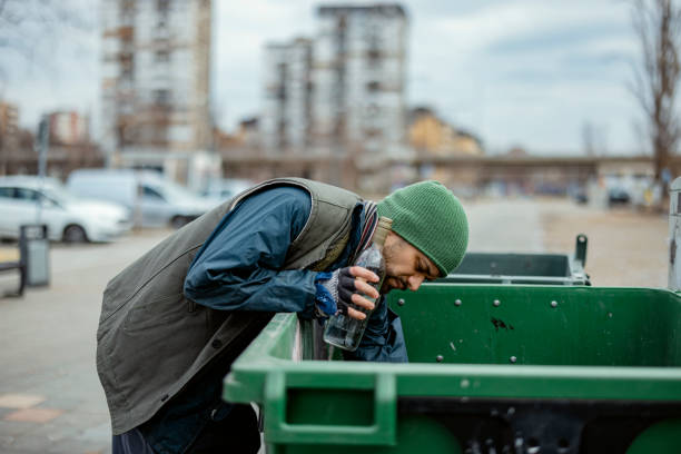 Homeless Looking for Food in Waste Containers. Homelessness Social Issues Concept.