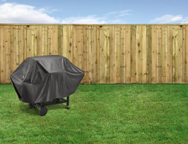 istock BBQ grill covered in a backyard with a fence 1995734268
