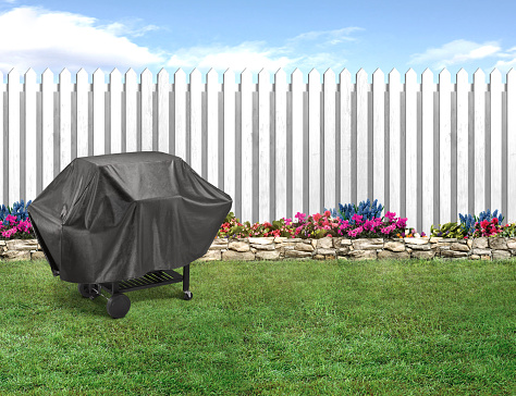 BBQ grill covered with a black protector cover