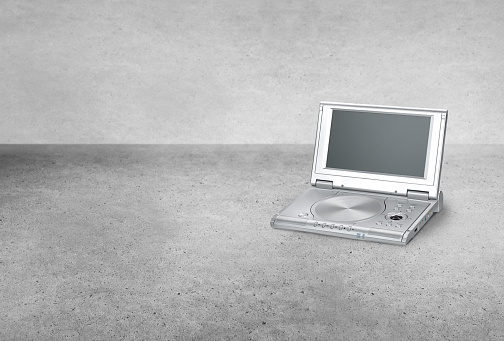 Retro old style portable DVD player with a screen on a background