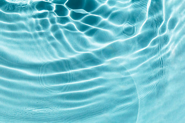 istock Textured water background with sun glare 1995738400