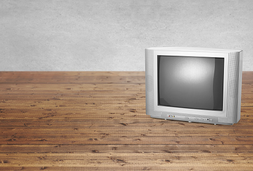 Retro old style tube tv on a wood table top background