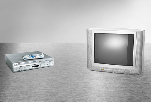Retro old style tube tv and a VCR player with a remote control