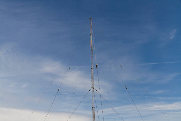 istock Radio mast against blue sky with cloud. 1995751781