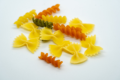 Various pasta varieties arranged on a leaf-shaped tablecloth