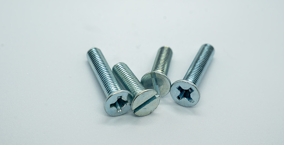 Four hexagonal bolts arranged on a white background