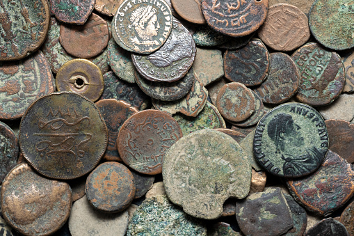 A collection of antique coins, relics, historical artifacts of the past from bygone eras.