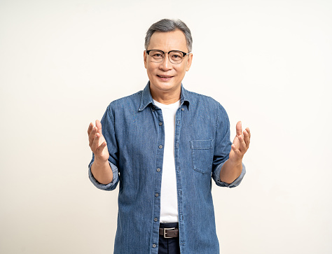 Handsome asian mature old man standing hands palm up on isolated white background. Happy Portrait of cheerful smiling senior asian man looking at camera. Mature People and lifestyle