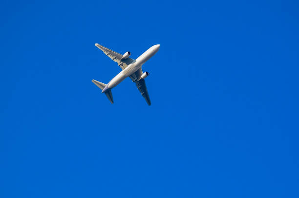 istock Big passenger plane in the blue sky 1995812317