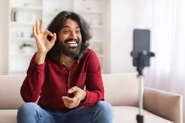 Photo of Cool indian guy influencer streaming from home