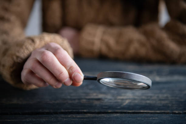 istock Woman looking through Magnifying Glass 1995823358