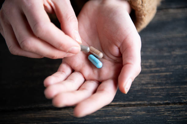 istock Woman taking vitamins and supplements 1995825940