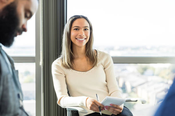 istock Female college student smiles for camera during class 1995828619