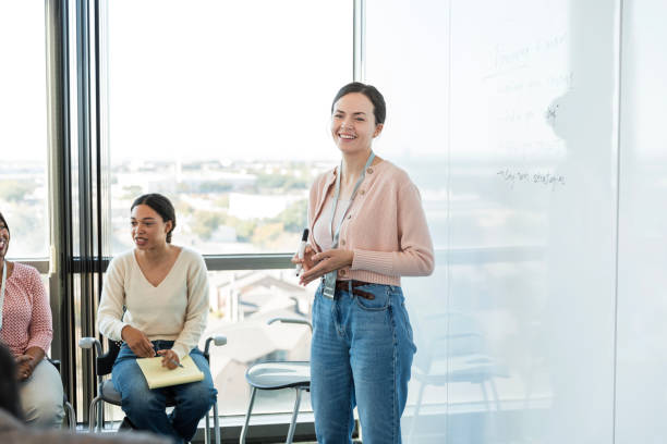 istock Female speaker smiles at unseen person in group 1995828633