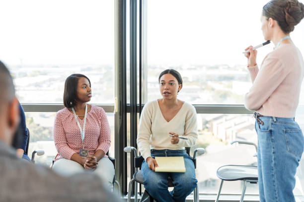 istock Diverse team listens as young woman shares ideas 1995828636