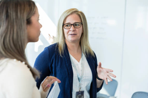 istock Female student talks to female professor 1995828638