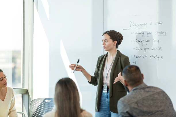 istock Female CEO speaks to diverse employees about developing vision 1995829157