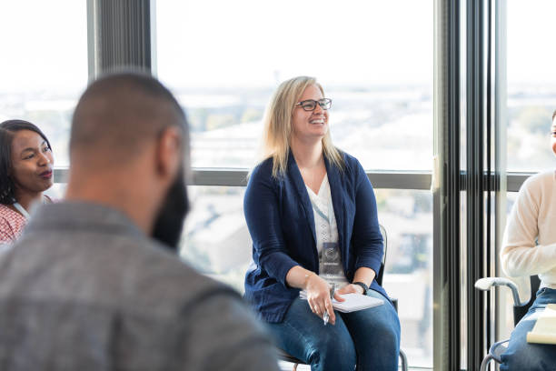 istock Diverse employees smile and laugh at unseen boss's comments 1995829163