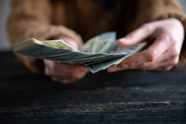 istock Hands holding dollar cash 1995830240