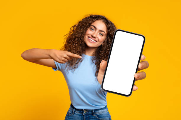 istock Happy woman pointing at blank smartphone screen 1995838194