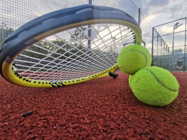 yellow tennis balls and racquet on hard tennis court surface, top view tennis scene - tennis baseline fun sports and fitness foto e immagini stock