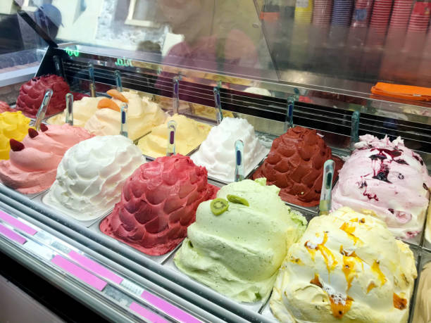 various flavors ice creams in display freezer - ice cream parlor ice cream dessert italian culture foto e immagini stock
