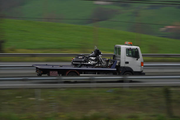 Roadside assistance crane transporting a large displacement motorcycle on a highway in Spain