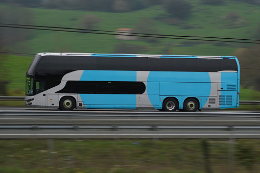 Passenger bus traveling on a highway in Spain. Concept: passenger transport by road, discretionary service