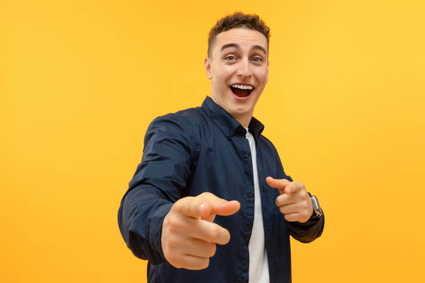 istock Handsome guy pointing at camera, isolated on yellow 1995890611