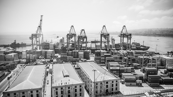 Panorama of container port of Valparaiso with large cranes and many big containers on the coast of Chile