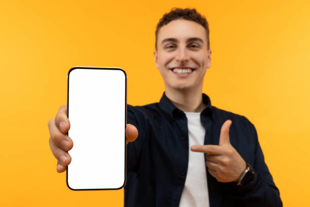 istock Phone with white blank screen in man hand 1995891703